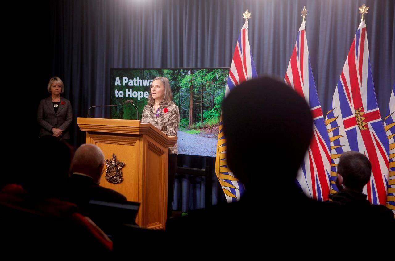 Provincial health officer Dr. Bonnie Henry looks on as chief coroner Lisa Lapointe discusses details about the province’s application for decriminalization in the next step to reduce toxic drug deaths during a news conference in the press gallery at the legislature in Victoria, Monday, Nov. 1, 2021. THE CANADIAN PRESS/Chad Hipolito