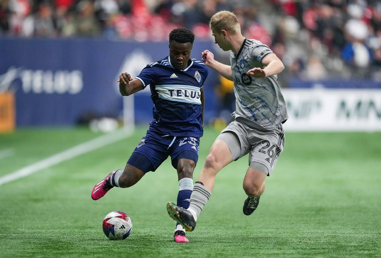 Vancouver Whitecaps’ Javain Brown, left, tries to move the ball past CF Montreal’s Robert Thorkelsson during the second half of an MLS soccer game in Vancouver, on Saturday, April 1, 2023. The Vancouver Whitecaps say they cannot underestimate CF Montreal, their Canadian Championship opponents, heading in to Wednesday night’s cup final match. THE CANADIAN PRESS/Darryl Dyck