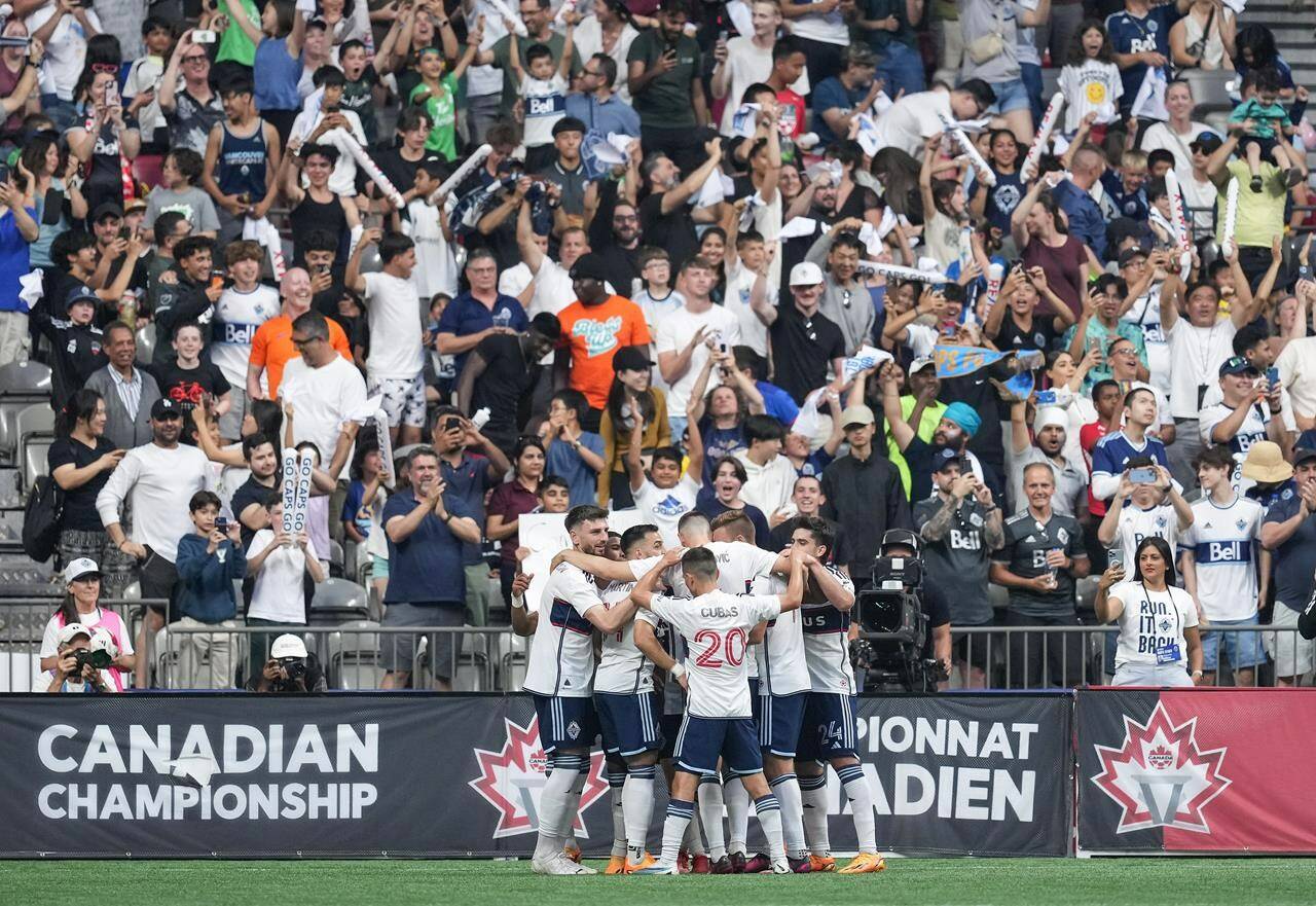 Vancouver Whitecaps players celebrate Ryan Gauld’s penalty kick goal against CF Montreal during the second half of the Canadian Championship soccer final, in Vancouver, on Wednesday, June 7, 2023. THE CANADIAN PRESS/Darryl Dyck