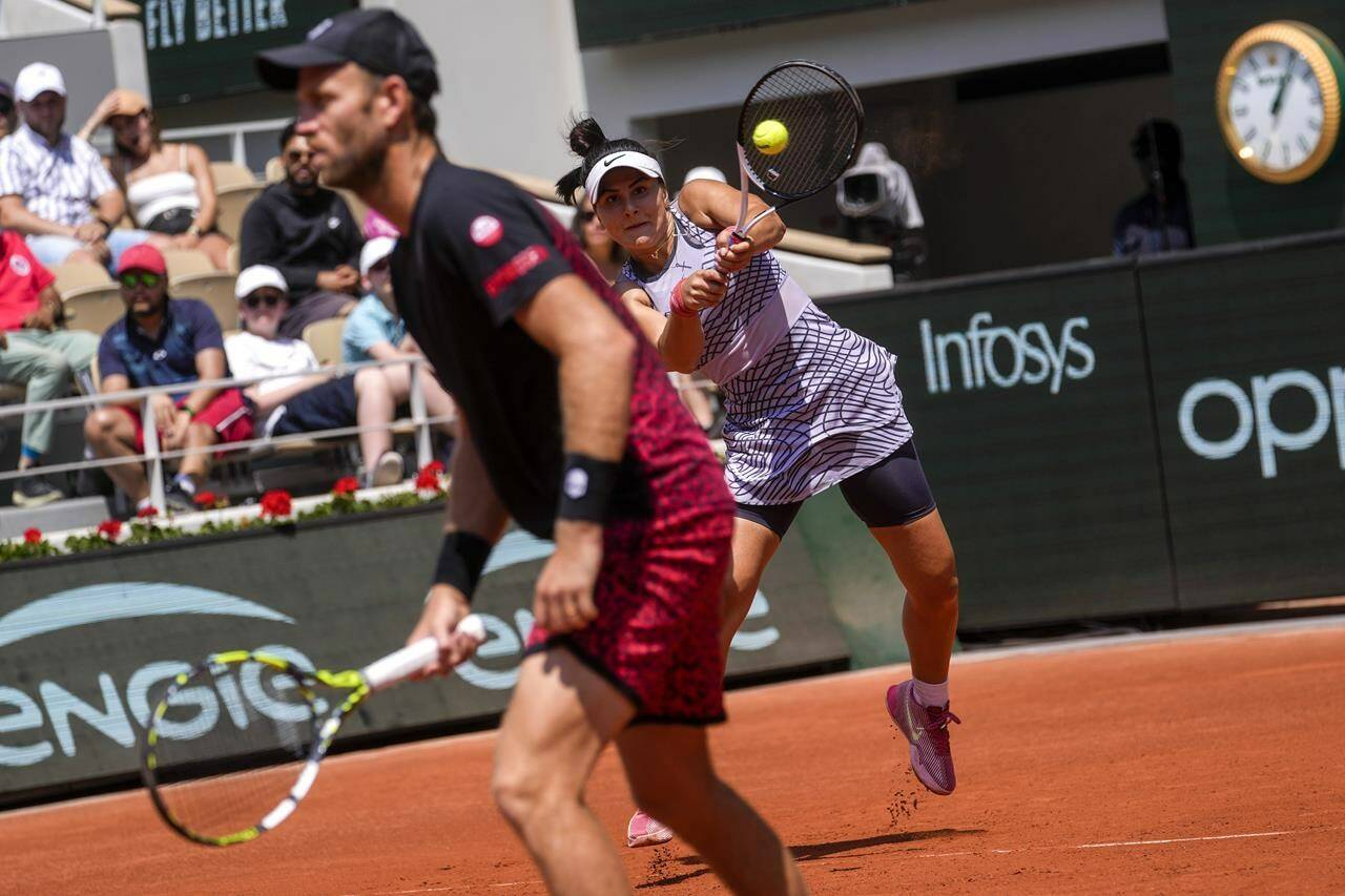 Canada’s Bianca Andreescu, rear, and New Zealand’s Michael Venus play a shot against Japan’s Miyu Kato and Germany’s Tim Puetz during their mixed doubles final match of the French Open tennis tournament at the Roland Garros stadium in Paris, Thursday, June 8, 2023. (AP Photo/Thibault Camus)