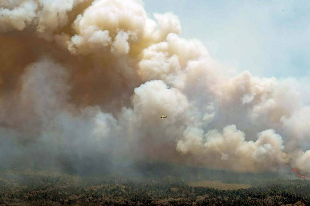 The agency co-ordinating the deployment of U.S. firefighters and equipment to Canada says it is keeping a wary eye on its own looming fire season. The U.S. National Interagency Fire Center says there are currently 345 federal firefighters and support personnel helping out north of the border. In this aerial image, an aircraft, center, flies near a wildfire burning near Barrington Lake in Shelburne County, Nova Scotia, on Wednesday, May 31, 2023. Communications Nova Scotia/The Canadian Press via AP