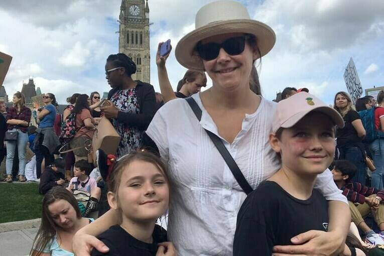 Jennifer Austin is pictured with her children, Izzy and James, at a climate strike event in Ottawa on Friday, Sept. 27, 2019 in a family handout photo. Austin is one of many Canadians dealing with climate anxiety as wildfire smoke enveloped large swaths of Canada. (Jennifer Austin/Contributed to The Canadian Press)