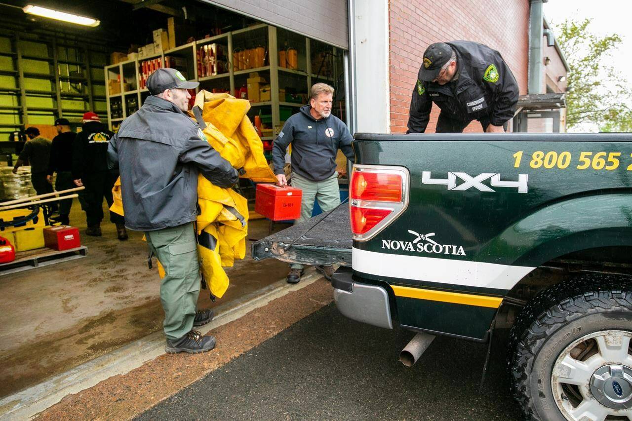 Firefighters from the Northeastern United States help load a truck with supplies in Shubenacadie, N.S., on Saturday, June 3, 2023, to assist with fighting wildfires in Nova Scotia. THE CANADIAN PRESS/Kelly Clark