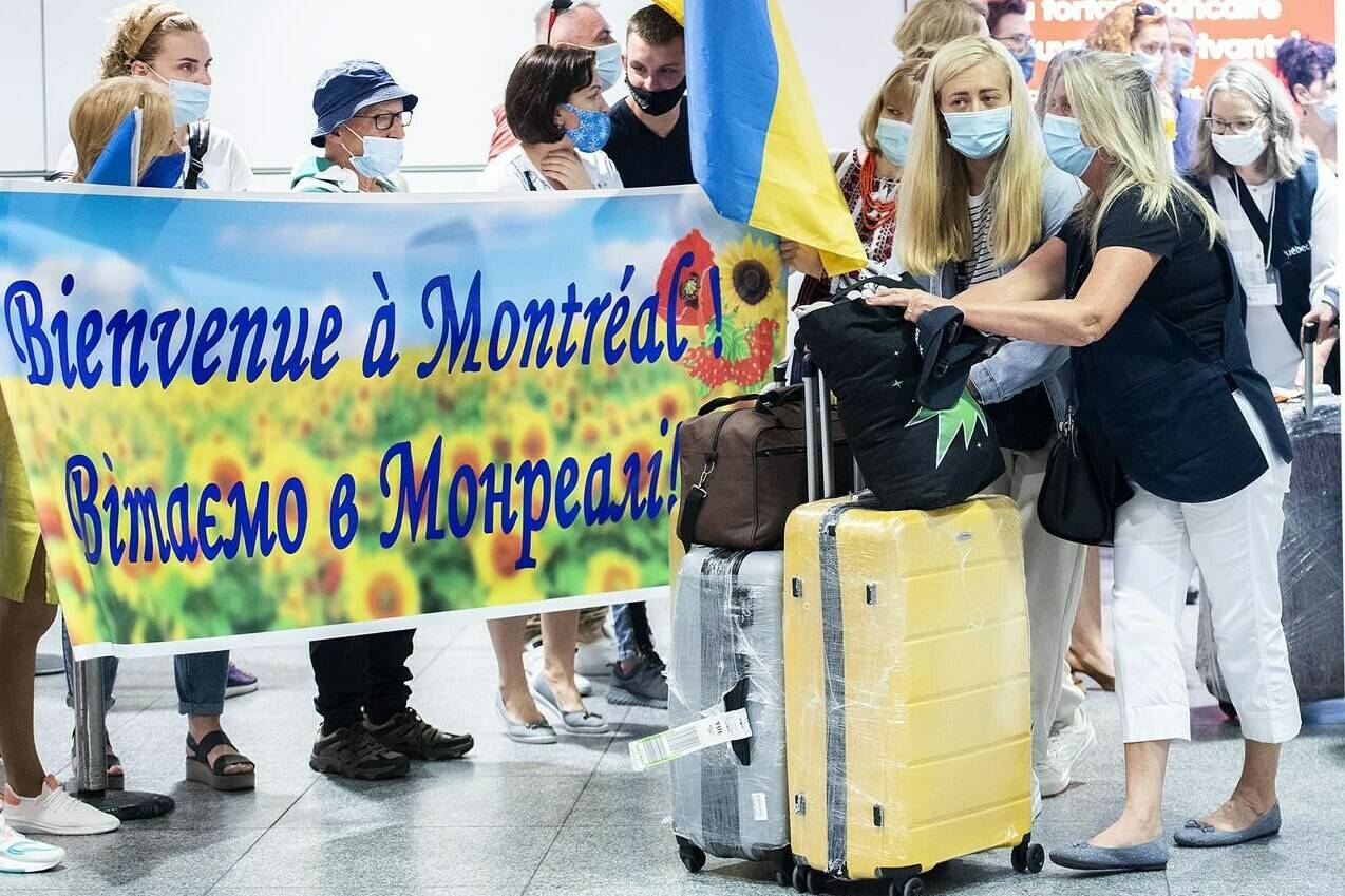 Ukrainian nationals fleeing the ongoing war in Ukraine arrive at Trudeau Airport in Montreal, Sunday, May 29, 2022. Stakeholders and experts say it may be time to offer more permanent status to Ukrainians who fled to Canada from the Russian invasion, but Canada will need to consult carefully with the Ukrainian government first. THE CANADIAN PRESS/Graham Hughes