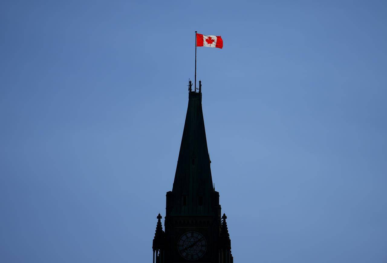 The Canada flag on the Peace Tower is lit up by morning light on Parliament Hill in Ottawa on Tuesday, May 9, 2023. A new poll suggests only one third of Canadians support the city of Mississauga, Ont., proposing to ask the Federal government to change the lyrics of the national anthem, O Canada. THE CANADIAN PRESS/Sean Kilpatrick