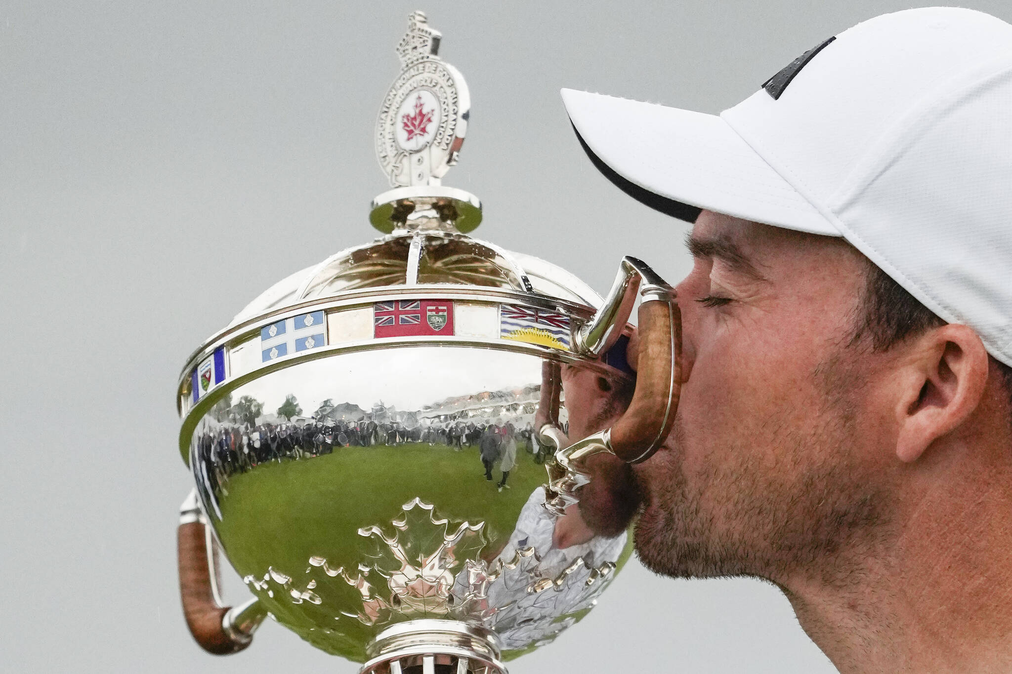Canadian Nick Taylor kisses the trophy after winning the Canadian Open golf championship in Toronto on Sunday, June 11, 2023. THE CANADIAN PRESS/Andrew Lahodynskyj