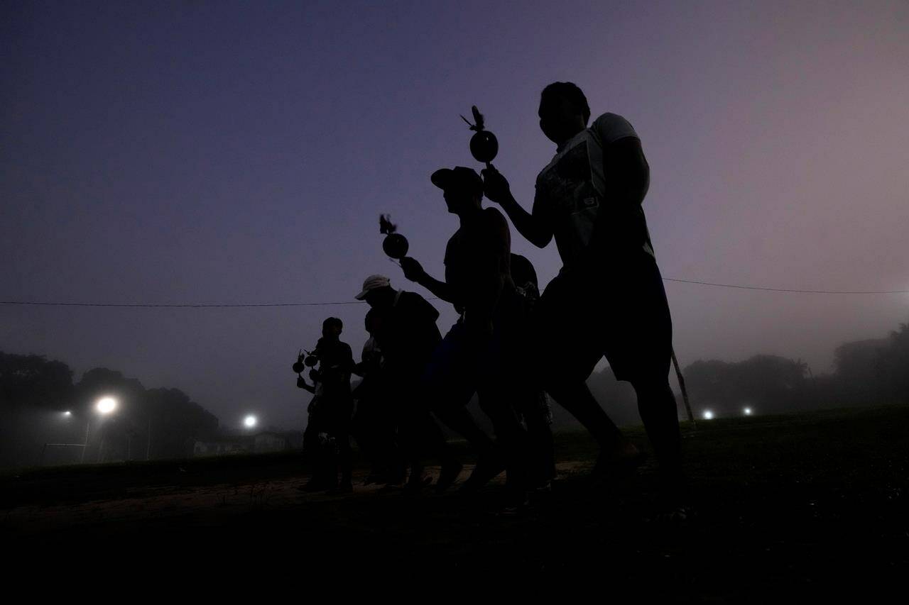 Indigenous men take part in the ritual dance during the final and most symbolic day of the Wyra’whaw coming-of-age festival at the Ramada ritual center, in the Tenetehar Wa Tembe village, located in the Alto Rio Guama Indigenous territory in Para state, Brazil, Sunday, June 11, 2023. Known as the Menina Moca in Portuguese, the three-day festival is for adolescent boys and girls in Brazil’s Amazon. (AP Photo/Eraldo Peres)
