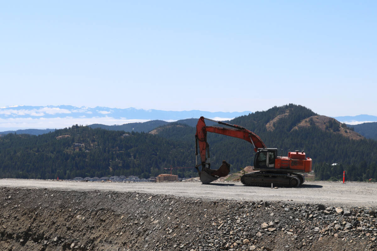 A machinery operator works on a gravel road off the side of Bear Mountain Parkway in Langford on May 29. (Bailey Moreton/News Staff)