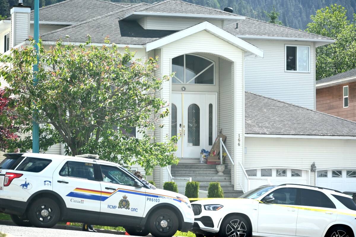 Prince Rupert RCMP vehicles and yellow crime scene tape can be seen cordoning off a multi-residence property numbered 166 and 168 Silversides Drive where four people were found deceased on June 13. (Photo: K-J Millar/The Northern View)