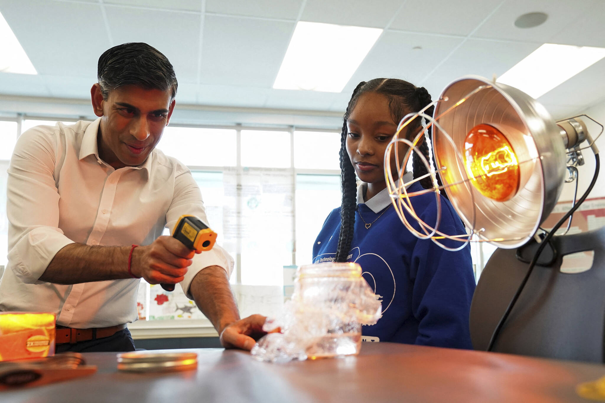 British Prime Minister Rishi Sunak takes part in a science experiment as he visits the Friendship Technology Preparatory High School during his trip to Washington, DC, Wednesday, June 7, 2023. (Kevin Lamarque/Pool Photo via AP)