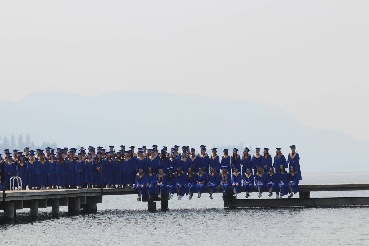 Smoke clouded the picturesque view down Kalamalka Lake as Coldstream’s grad class posed for photos on the Kal Lake dock Thursday, June 15, 2023. (Bowen Assman - Morning Star)