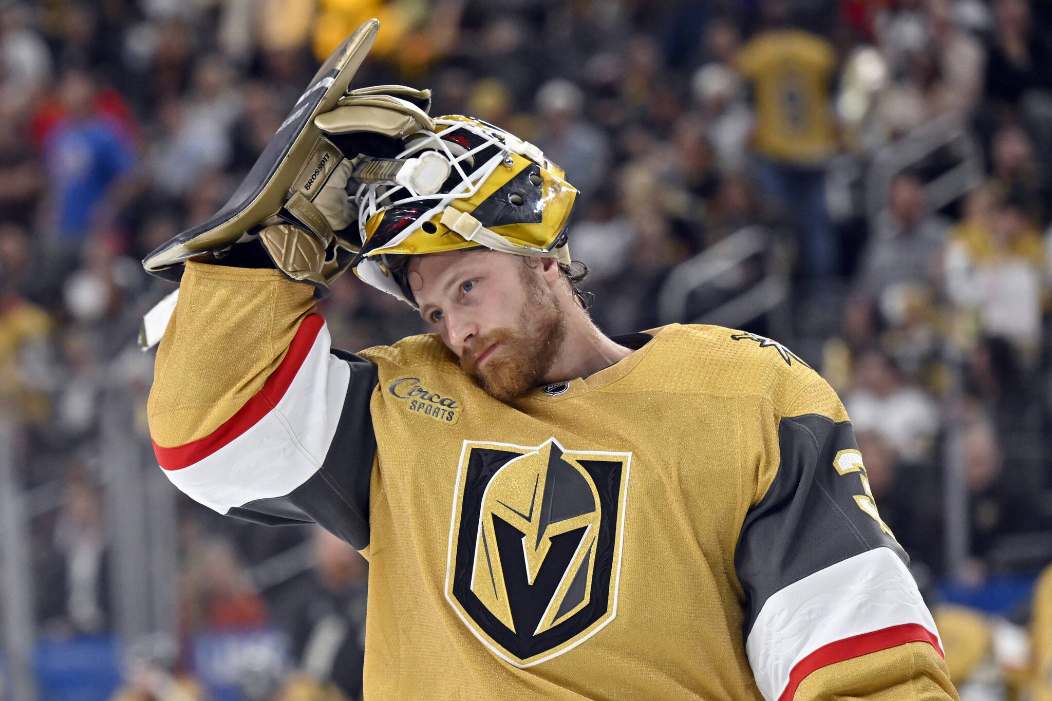 Vegas Golden Knights goaltender Laurent Brossoit adjusts his helmet during the third period of Game 5 of the team’s NHL hockey Stanley Cup first-round playoff series against the Winnipeg Jets on Thursday, April 27, 2023, in Las Vegas. (AP Photo/David Becker)