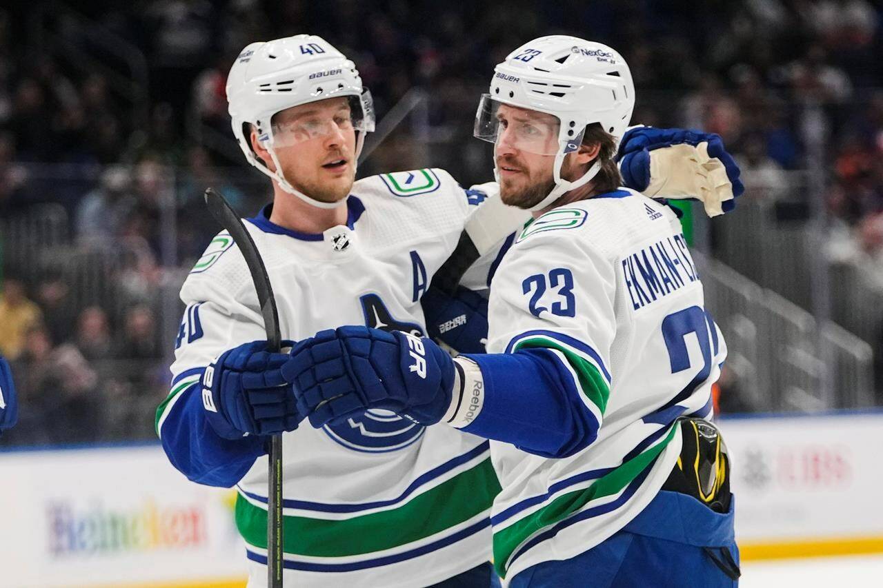 Vancouver Canucks’ Oliver Ekman-Larsson (23) celebrates with teammate Elias Pettersson (40) after scoring a goal during first period NHL hockey action against the New York Islanders, in Elmont, N.Y., Thursday, Feb. 9, 2023. The Vancouver Canucks have bought out Oliver Ekman-Larsson, making the defenceman an unrestricted free agent. THE CANADIAN PRESS/AP-Frank Franklin II