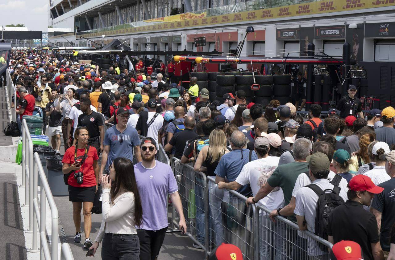 Race fans walk through pit lane during the open house at the Canadian Grand Prix Thursday, June 15, 2023, in Montreal. Residents and tourists, alike, are excited for the return of the Canadian Grand Prix, the unofficial kickoff to the city’s summer festival season. THE CANADIAN PRESS/Ryan Remiorz