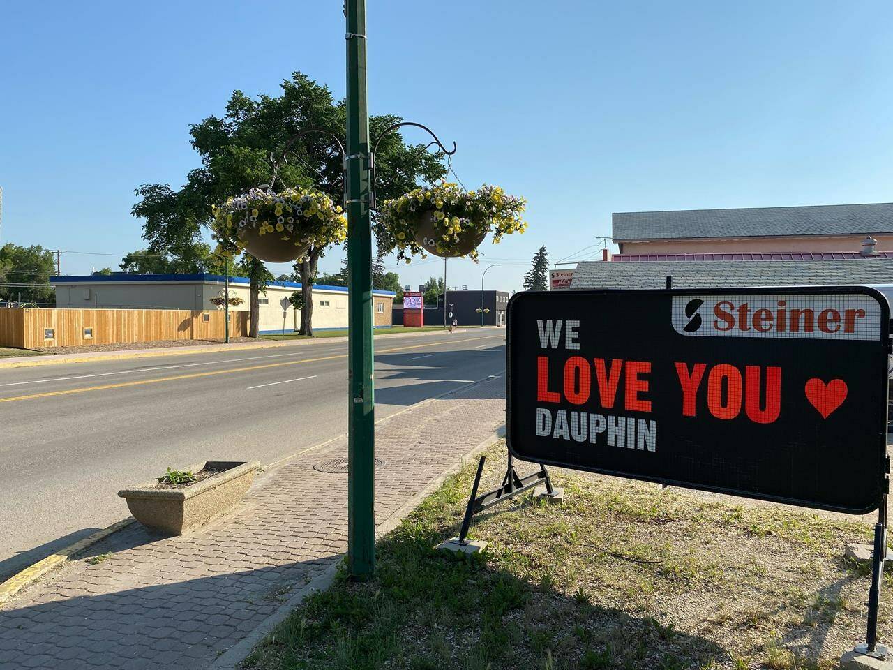A sign is seen outside a business in Dauphin, Man., on Saturday June 17, 2023. The mood remains sombre in the city as area residents learn more details of a highway crash that killed 15 people and injured 10. THE CANADIAN PRESS/Steve Lambert