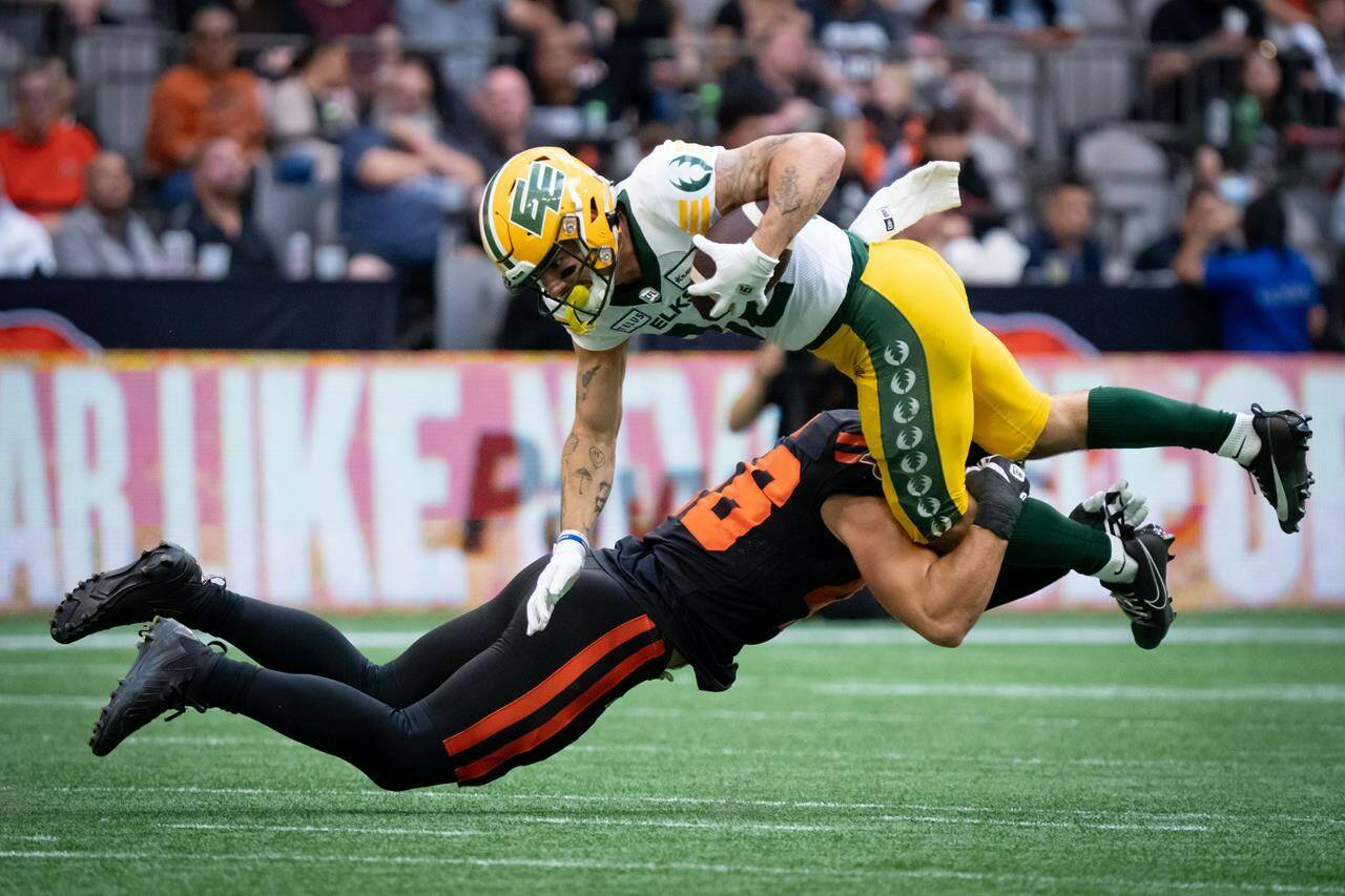 B.C. Lions linebacker Ben Hladik (46) tackles Edmonton Elks wide receiver Vincent Forbes-Mombleau (82) during the first half of a CFL football game, in Vancouver, on Saturday, June 17, 2023. THE CANADIAN PRESS/Ethan Cairns