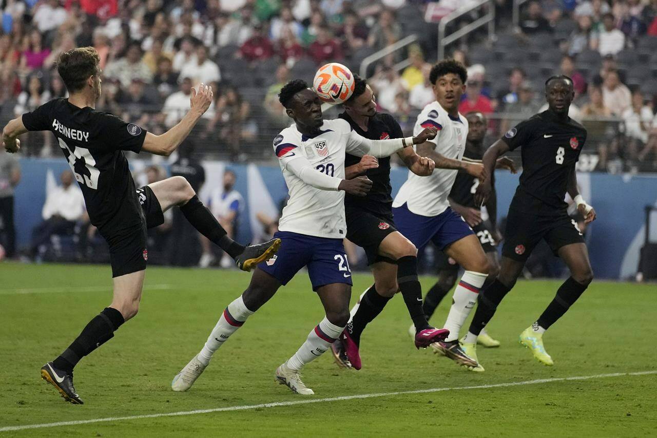 Folarin Balogun of the United States, centre left, and Stephen Eustaquio, of Canada, centre right, battle for the ball during the first half of a CONCACAF Nations League final match Sunday, June 18, 2023, in Las Vegas. THE CANADIAN PRESS/AP-John Locher