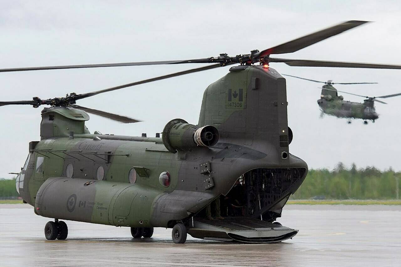 Two RCAF CH-147F Chinook, multi-mission, medium to heavy-lift helicopters are seen at CFB Bagotville in Bagotville, Que. on Thursday, June 7, 2018. The Royal Canadian Air Force says one of its military helicopters has been involved in an unspecified incident while operating in eastern Ontario early this morning. THE CANADIAN PRESS/Andrew Vaughan