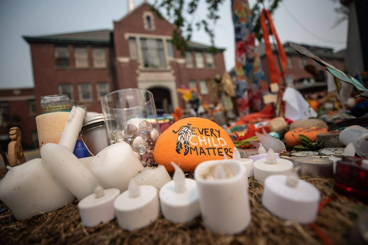 A rock with the message “Every Child Matters” painted on it sits at a memorial outside the former Kamloops Indian Residential School, in Kamloops, B.C., on Thursday, July 15, 2021. The discovery of up to 215 remains on the grounds of the former residential school sparked a nationwide discussion about the residential school system. But a recent report has found a “a core group of Canadians continue to defend the Indian Residential Schools System” in downplaying or denying its legacy. (THE CANADIAN PRESS/Darryl Dyck)