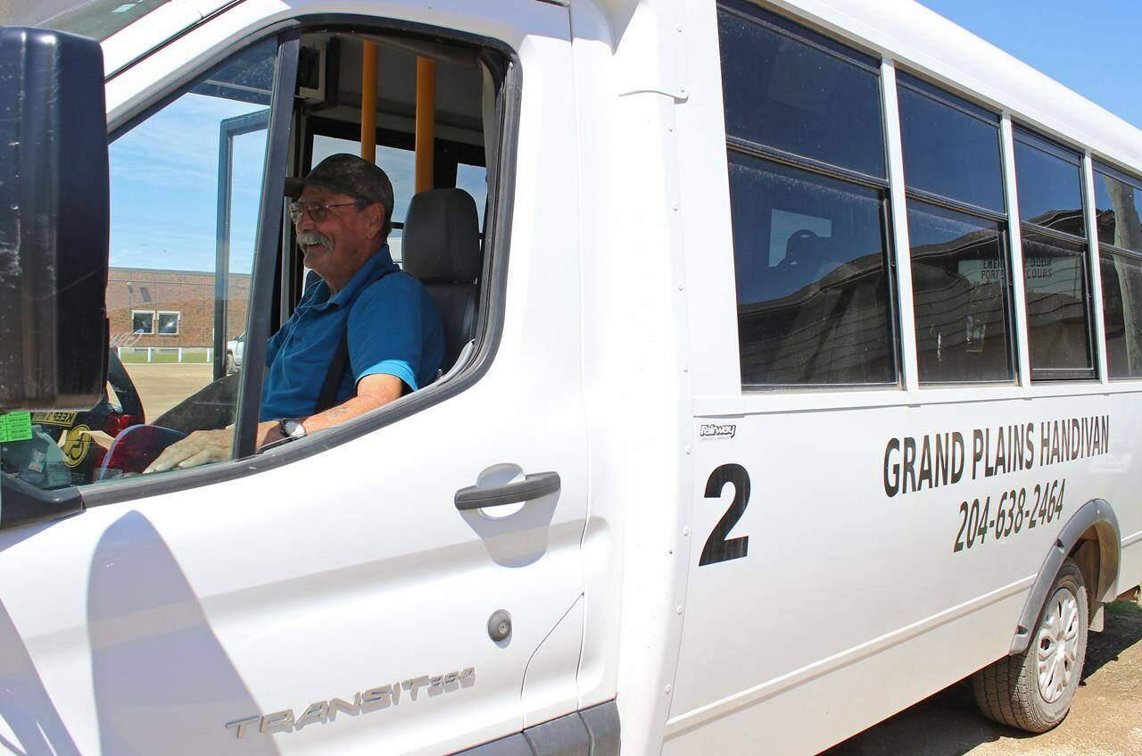 Doug Westhouse sits behind the wheel of a 12-passenger bus in Grandview, Man. on June 20, 2023. The coordinator and driver for Grand Plains Handivan transports people from Grandview and Gilbert Plains about 50 kilometres east to Dauphin for appointments, shopping and visits with family. THE CANADIAN PRESS/Kelly Geraldine Malone
