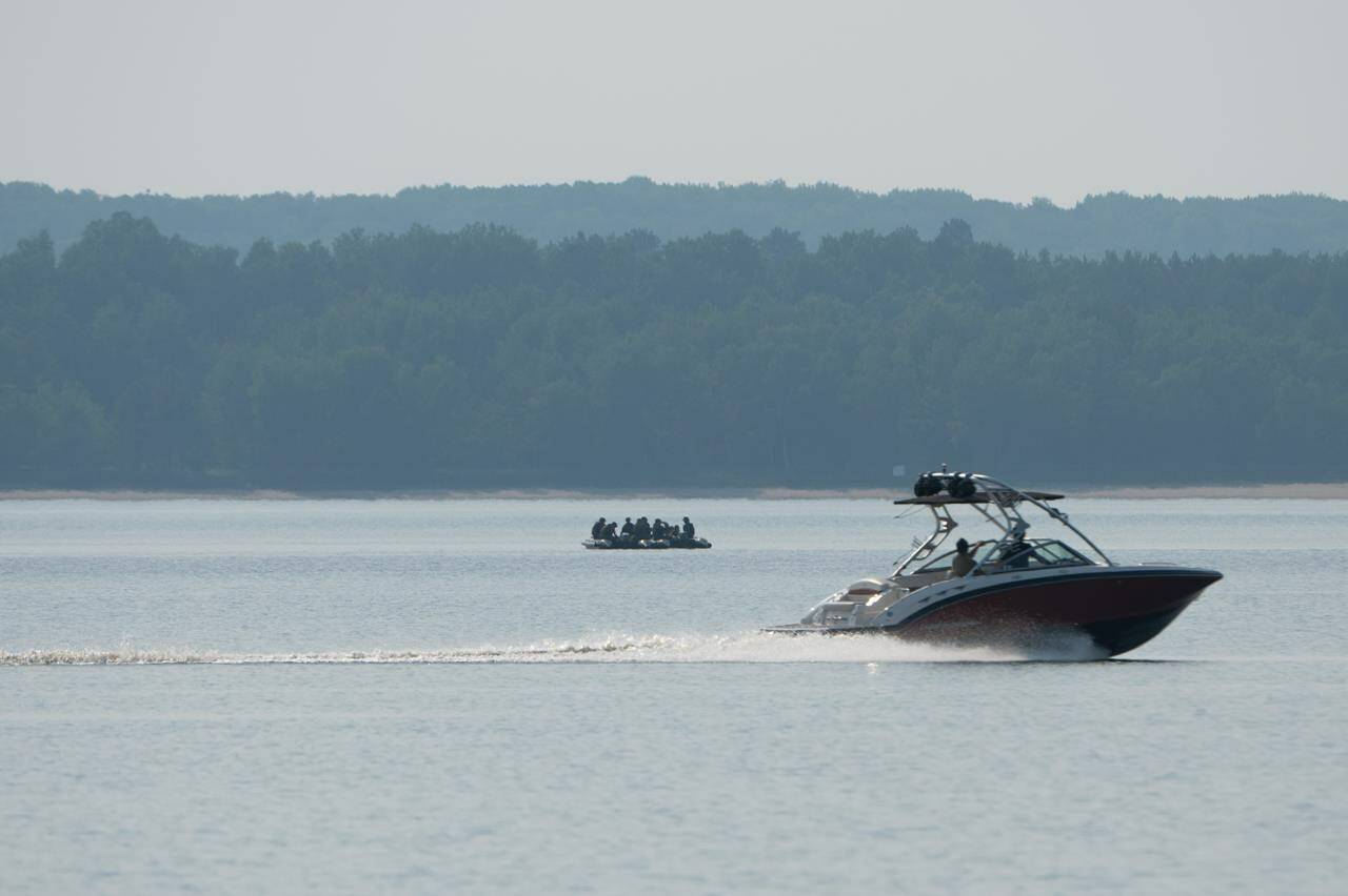 Canadian Armed Forces members search around a series of islands on the Ottawa River near Fort William in the Pontiac Regional County Municipality, Que. on Tuesday, June 20, 2023. THE CANADIAN PRESS/Spencer Colby