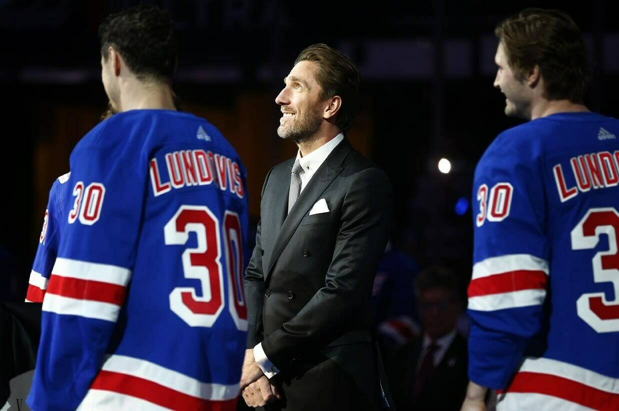 Former New York Rangers goaltender Henrik Lundqvist, center, watches as his number is retired before an NHL hockey game between the New York Rangers and the Minnesota Wild, in New York, Friday, Jan. 28, 2022. THE CANADIAN PRESS/AP-John Munson