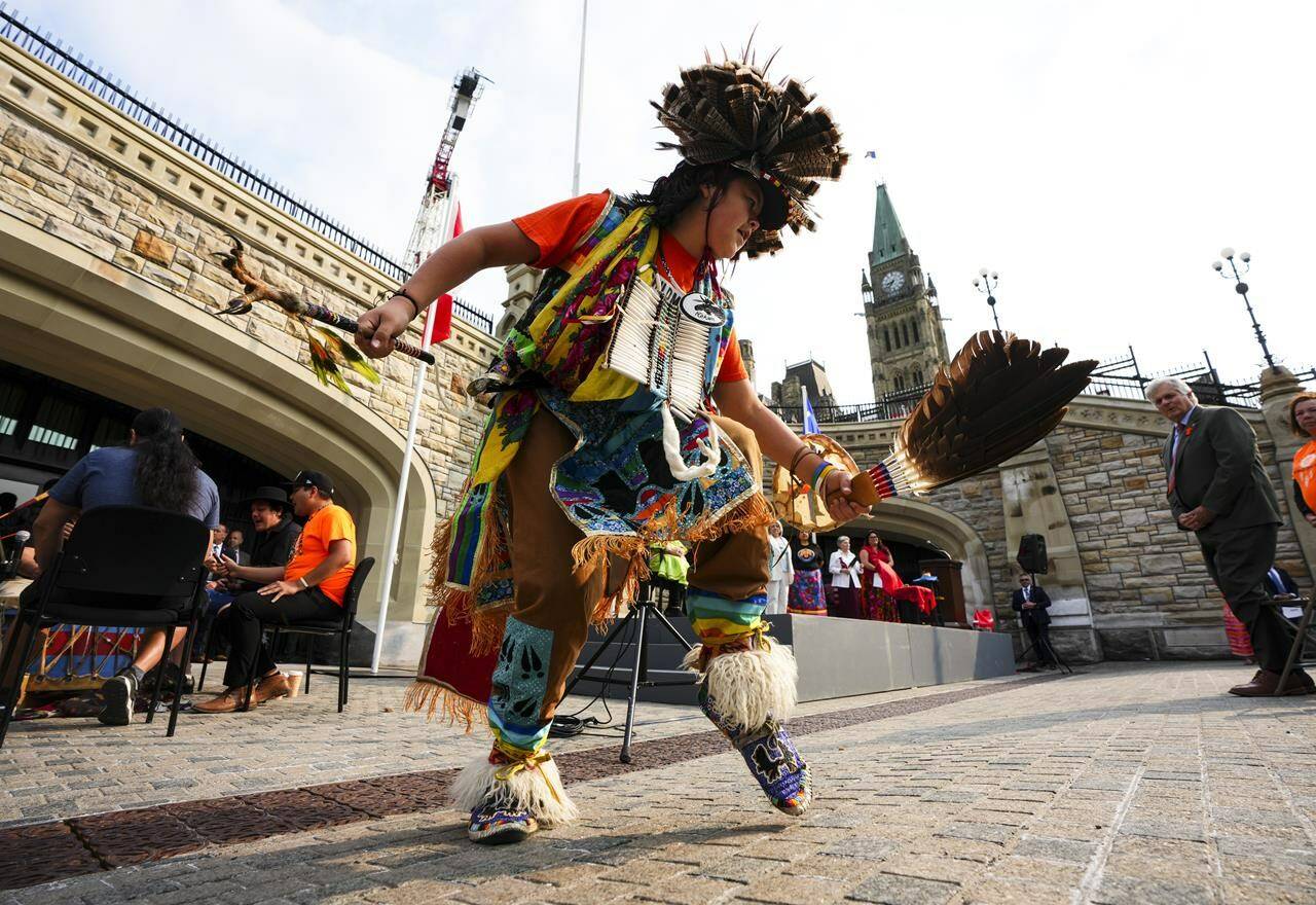Traditional dancer Odeshkun Thusky performs during a commemorative ceremony, Raising the Survivors’ Flag, on Parliament Hill in Ottawa on Wednesday, June 21, 2023. The ceremony is “in memory of the thousands of children who were sent to residential schools, of those who never returned, and in honour of the families whose lives were forever changed.” THE CANADIAN PRESS/Sean Kilpatrick