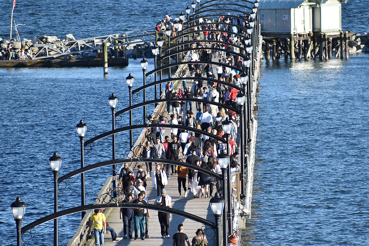 FILE - Crowds of people walk along the White Rock in 2020. On June 16, 2023, Canada’s population hit the 40-million mark, with the 40 millionth person possibly a non-permanent resident in B.C. (Aaron Hinks photo)