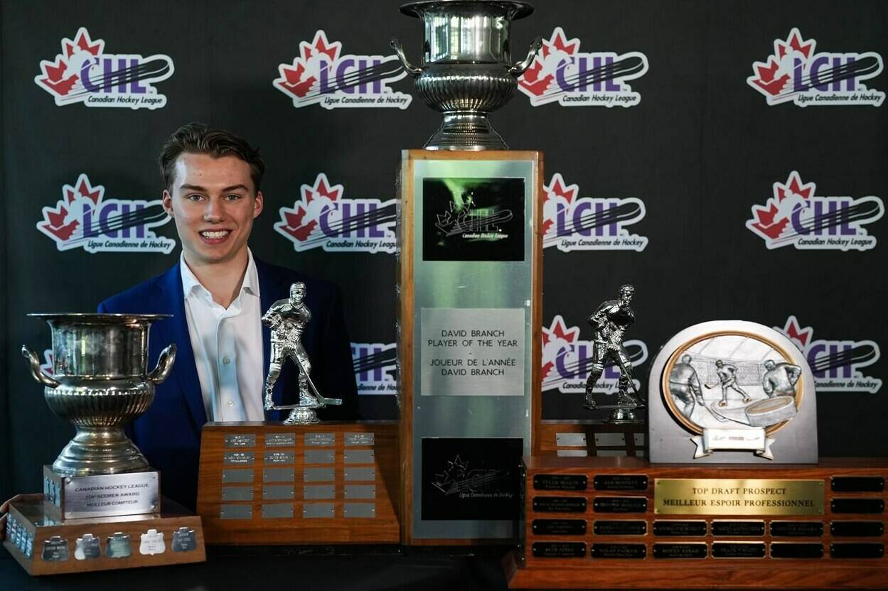 Regina Pats centre Connor Bedard poses for photographs with the trophies he received at the Canadian Hockey League awards ceremony, in Kamloops, B.C., on Saturday, June 3, 2023. Bedard, the presumed No. 1 pick of this year’s NHL draft won the CHL Top Prospect, Top Scorer, and David Branch Player of the Year awards. It’s the first time since the Top Scorer award was introduced in 1994 that a player has won all three in a single season. THE CANADIAN PRESS/Darryl Dyck