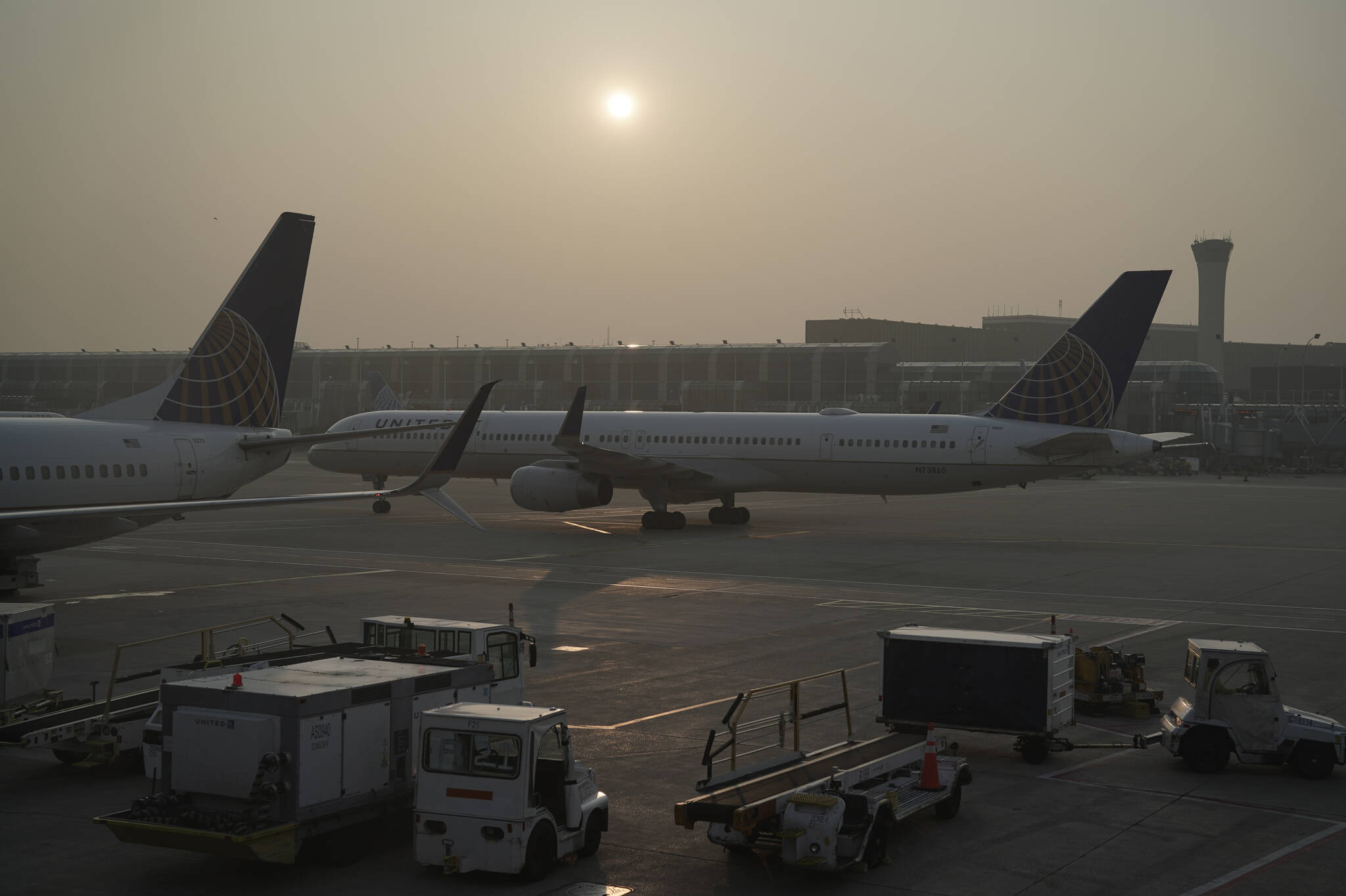 A plane taxis to the runway as smoke from wildfires in Canada is visible on Wednesday, June 28, 2023, at O’Hare International Airport in Chicago. (AP Photo/Joshua A. Bickel)