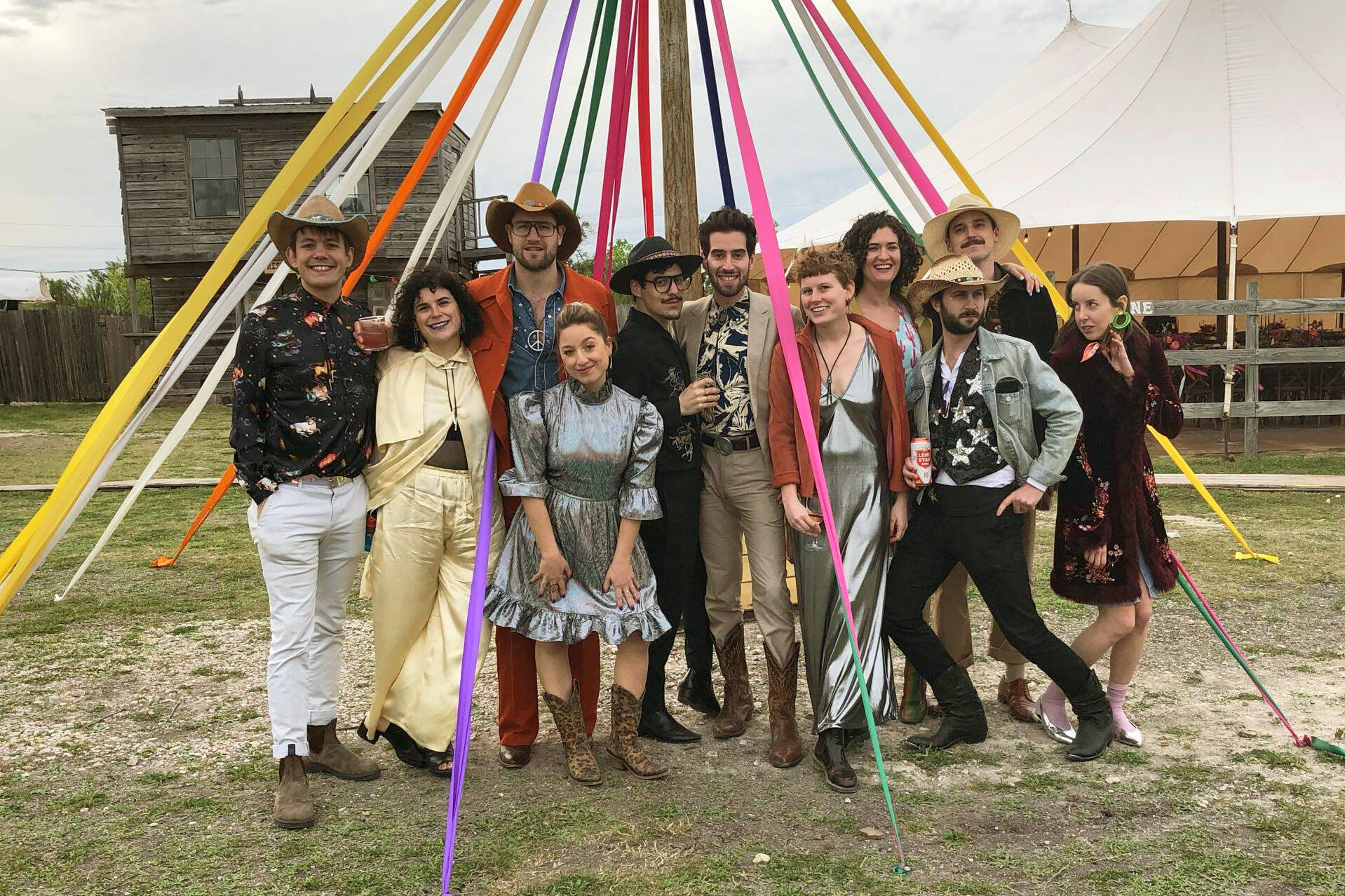 Wedding guests who adhered to the dress code of “Space Disco Cowboy,” pose at a wedding in Austin, Texas on March 30, 2019. More than ever, wedding guests are contending with nontraditional dress code requests. (Rikki Gotthelf via AP)