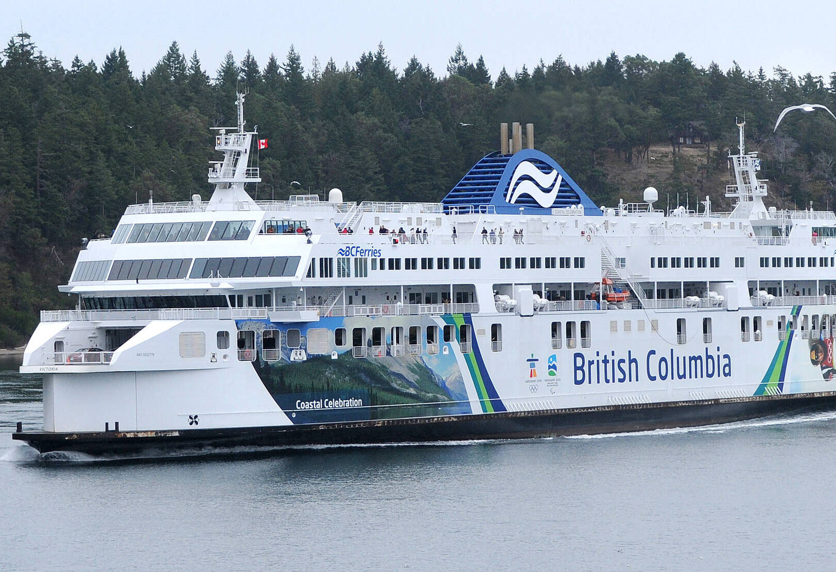 Passengers stand on the outside deck of the BC Ferries’ vessel Coastal Celebration in Active Pass during a sailing from Tsawwassen to Swartz Bay. The vessel is out of rotation this long weekend due to mechanical issues. (Black Press Media file photo)
