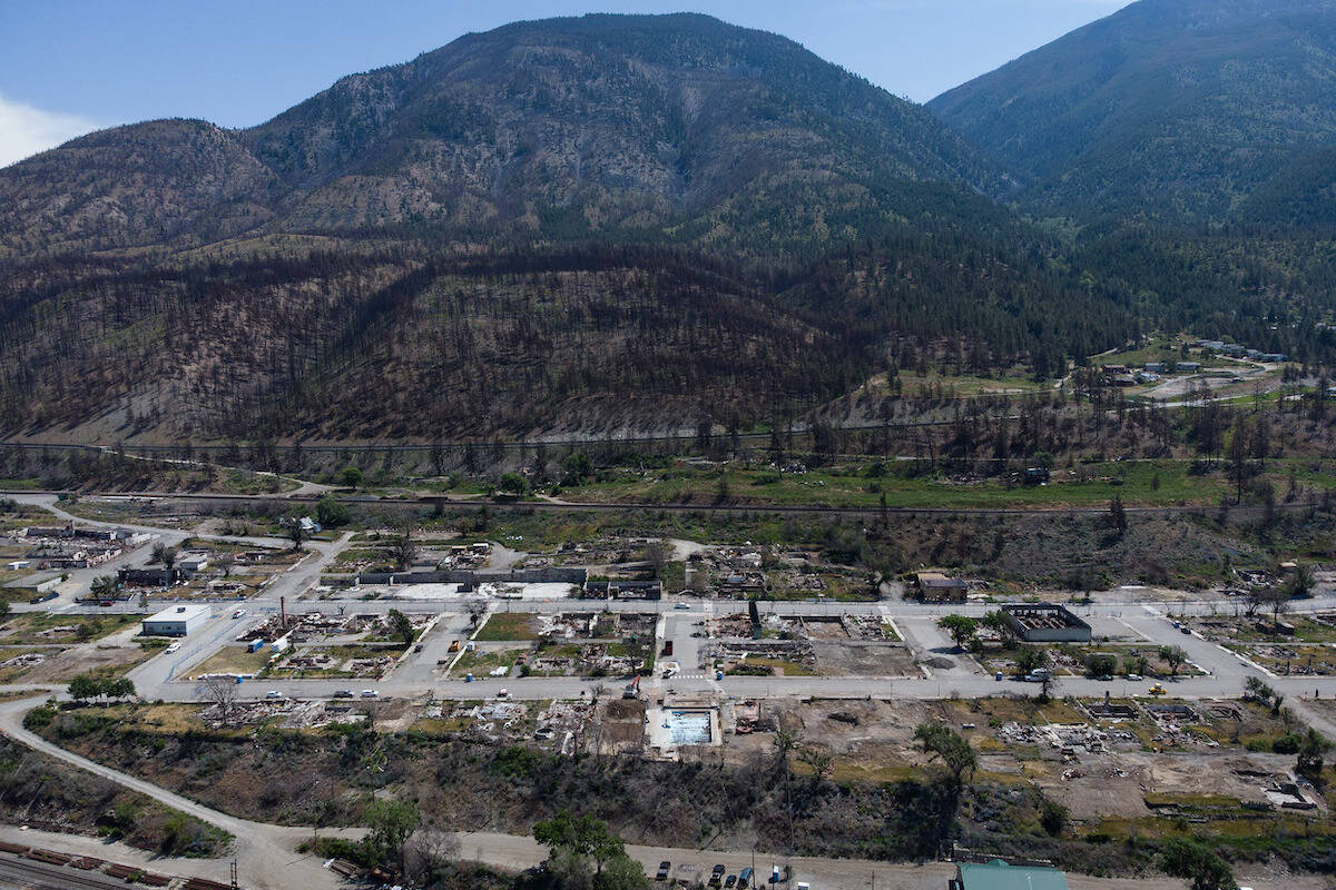 The remains of the village pool and debris covered properties that were destroyed by the 2021 wildfire are seen in Lytton, B.C., on Wednesday, June 15, 2022. THE CANADIAN PRESS/Darryl Dyck