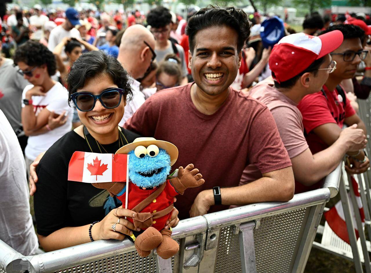 People attending Canada Day celebrations at LeBreton Flats hold a toy wearing RCMP style uniform in Ottawa on July 1, 2023. Canada’s capital city will see some festivities around Parliament Hill, but the main entertainment will be at LeBreton Flats, just west of downtown, where celebrations are expected to return to a sense of normalcy this year. THE CANADIAN PRESS/Justin Tang