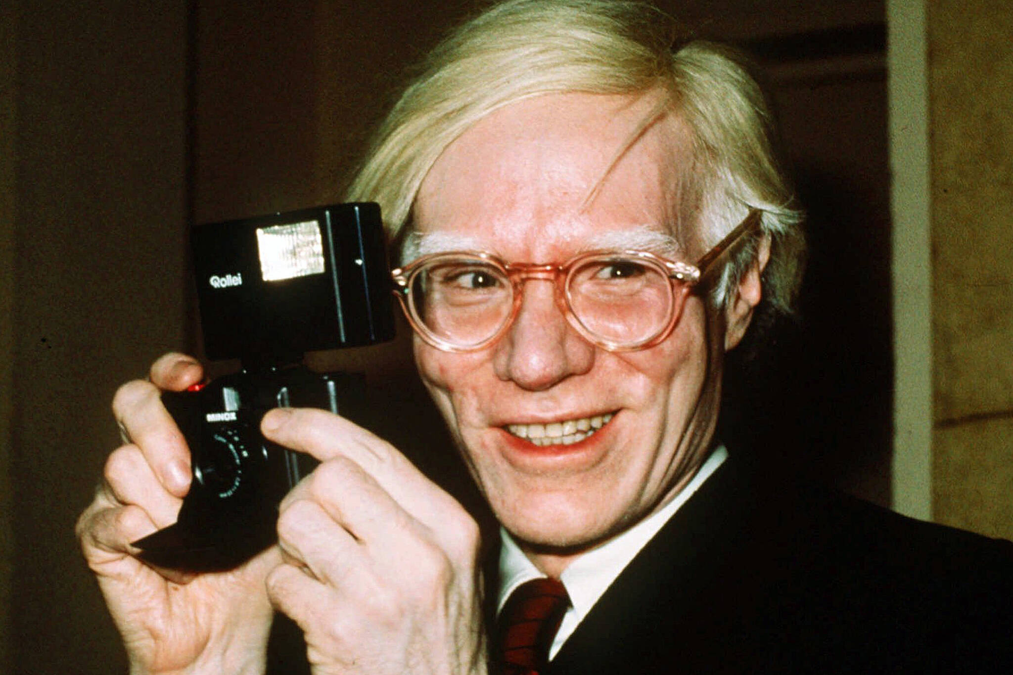 In this 1976 file photo, pop artist Andy Warhol smiles in New York. Artist Any Warhol and the musician Prince were both center stage Wednesday in a case at the Supreme Court, a copyright case that had the justices discussing topics from Cheerios to the Mona Lisa. (AP Photo / Richard Drew)