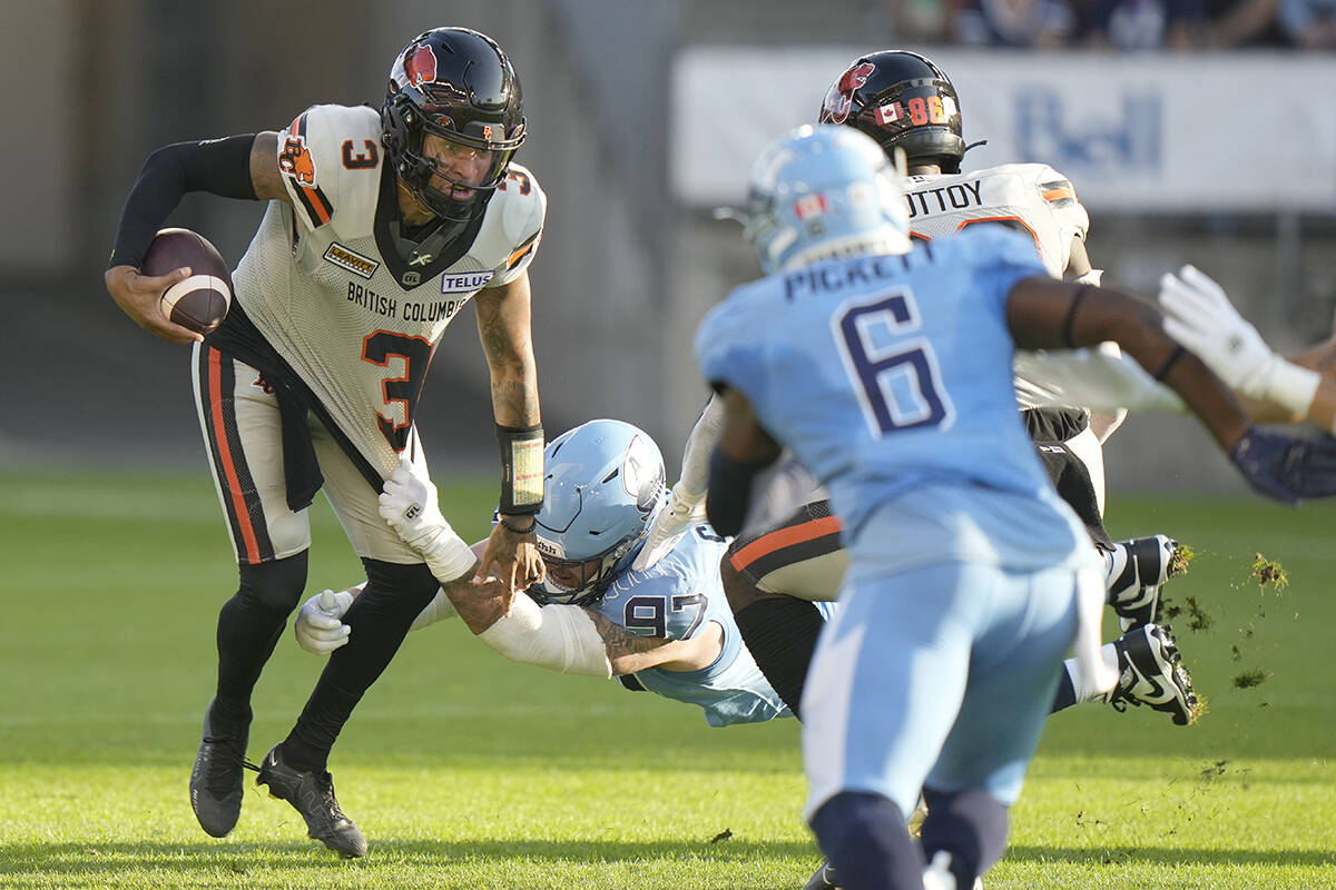 Toronto Argonauts defensive lineman Thomas Costigan (97) stops BC Lions quarterback Vernon Adams Jr. (3) during first half CFL action in Toronto on Monday, July 3, 2023. THE CANADIAN PRESS/Frank Gunn