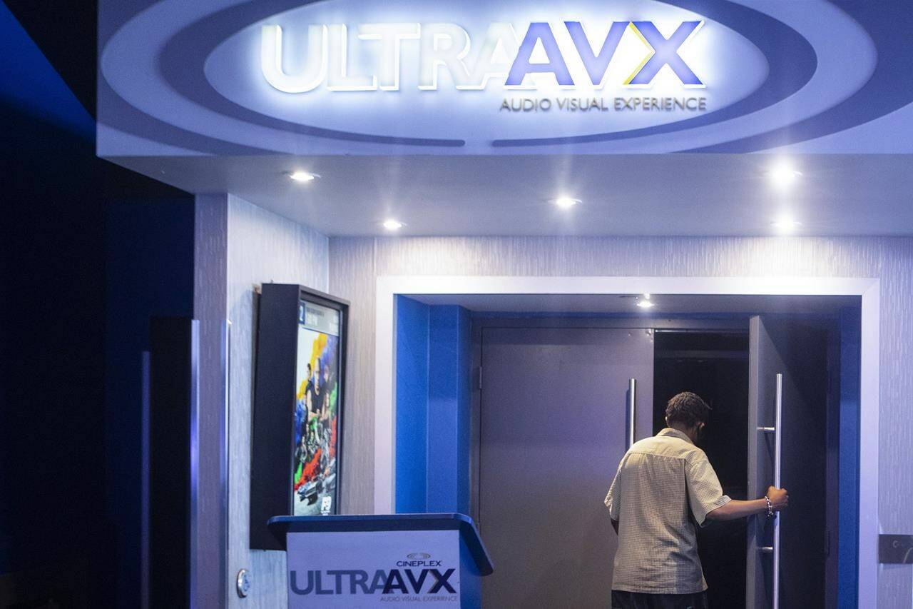 A moviegoer steps into an auditorium at a Cineplex Movie Theatre in Toronto on Friday, July 16, 2021. THE CANADIAN PRESS/Chris Young