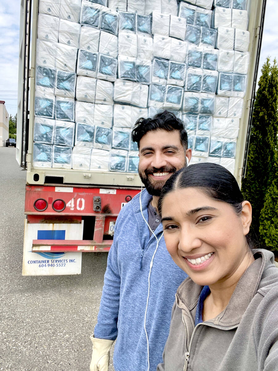 Simi and Harry Rajput unload a semi-truck containing their Green Giantz biodegradable briefs product. (Special to Langley Advance Times)