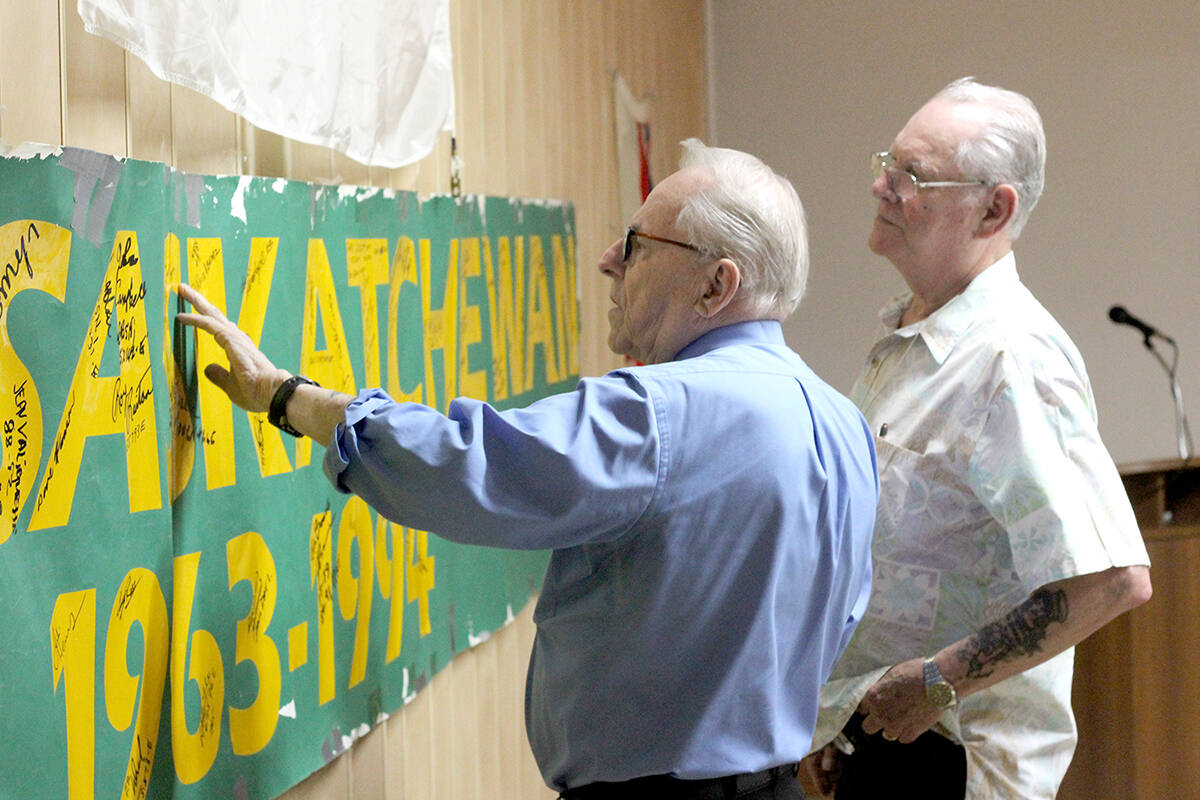 Former HMCS Saskatchewan shipmen Don Reid and Gary Robertson, during a reunion event June 17 at Nanaimo’s Royal Canadian Legion Branch 256, take a look at the names on an HMCS Saskatchewan banner that was displayed at the ship’s decommissioning ceremony in 1994 in Esquimalt. (Greg Sakaki/News Bulletin)