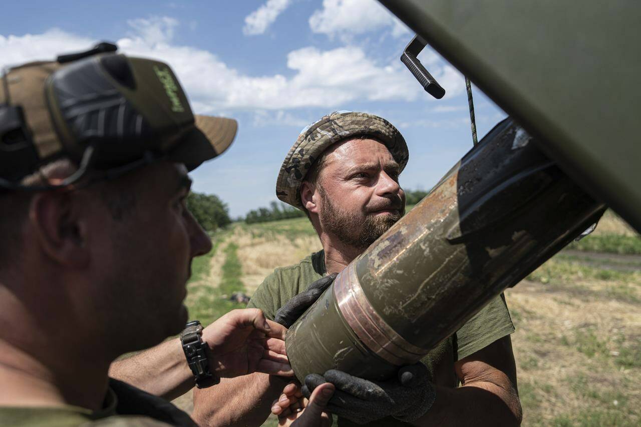 Ukrainian servicemen load a shell into a self-propelled howitzer “Bohdana” before firing towards Russian positions near Bakhmut, Ukraine, Friday, July 7, 2023. (AP Photo/Evgeniy Maloletka)