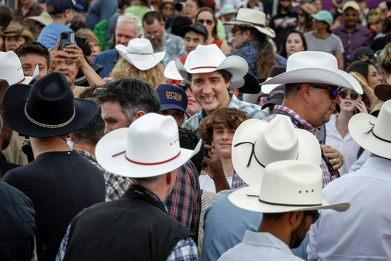 Prime Minister Justin Trudeau, centre, walks the grounds of the Calgary Stampede in Calgary, Friday, July 7, 2023. THE CANADIAN PRESS/Jeff McIntosh