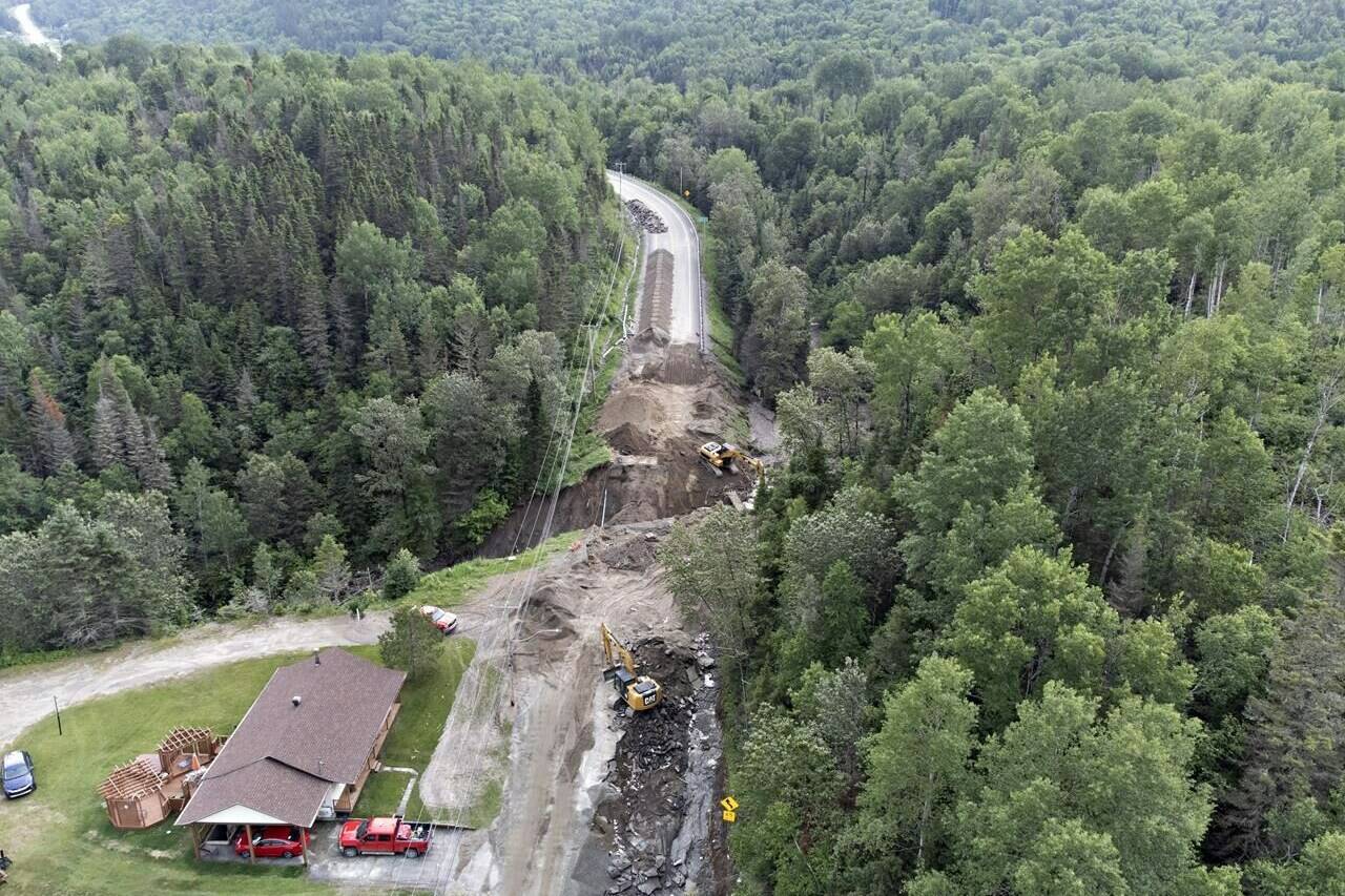 Crews begin repairs to a washed-out section of Highway 170 in Rivière-Éternité, Que., Sunday, July 2, 2023. Climate change could lead to more landslides in Quebec, like the one that killed two people on Saturday, said a researcher who studies the phenomenon. THE CANADIAN PRESS/Jacques Boissinot