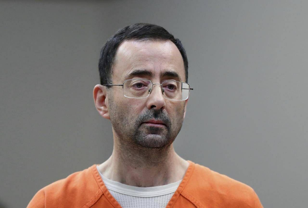 FILE - In this Nov. 22, 2017 file photo, Dr. Larry Nassar appears in court for a plea hearing in Lansing, Mich. Nassar, who was convicted of sexually abusing female gymnasts, was stabbed multiple times during an altercation with another incarcerated person at a federal prison in Florida. Two people familiar with the matter told The Associated Press the attack happened Sunday at United States Penitentiary Coleman in Florida. The people said he was in stable condition Monday. (AP Photo/Paul Sancya, File)