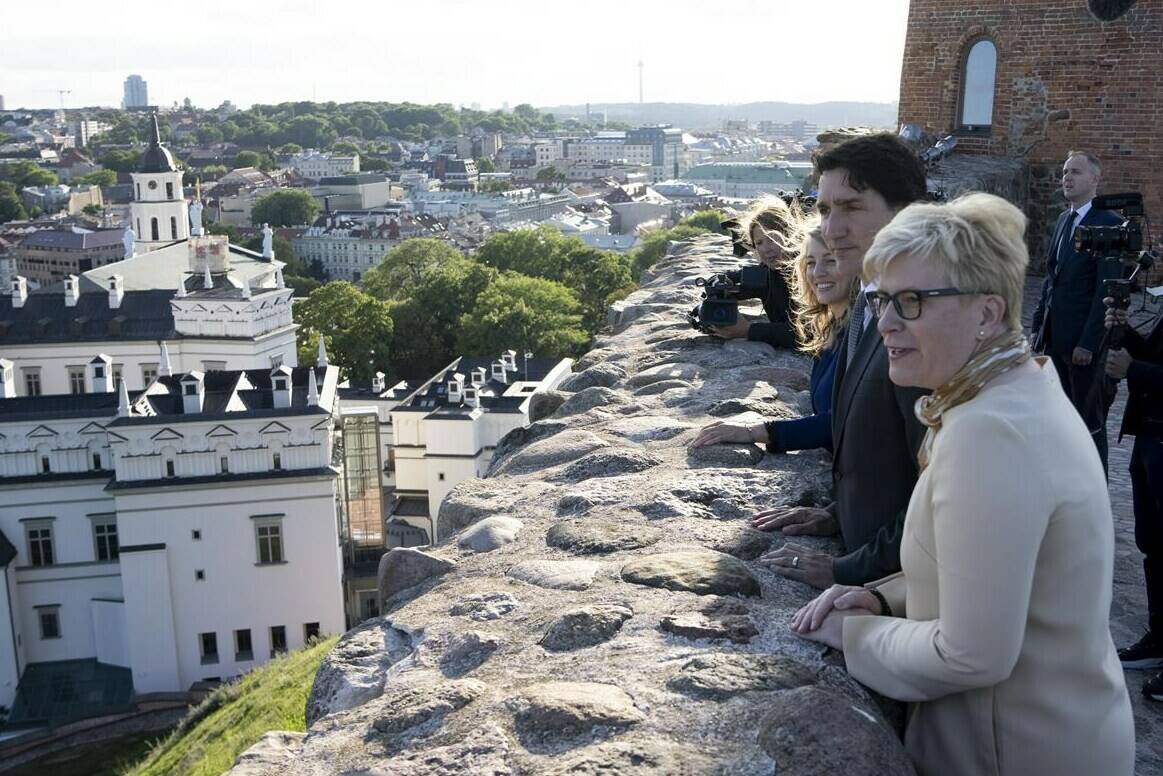 Lithuanian Prime Minister Ingrida Simonyte, Prime Minister Justin Trudeau and Foreign Affairs Minister Melanie Joly take in the view from the Gediminas Castle tower in Vilnius, Lithuania, Monday, July 10, 2023. THE CANADIAN PRESS/Adrian Wyld