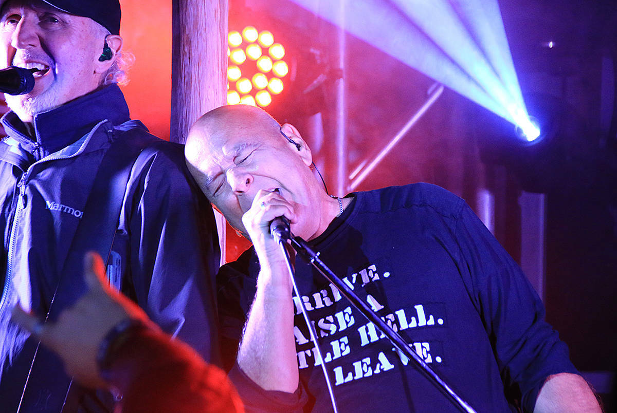 Trooper singer Ra McGuire leans into guitarist Brian Smith during a festival concert on Vancouver Island in 2018. Lexi Bainas photo