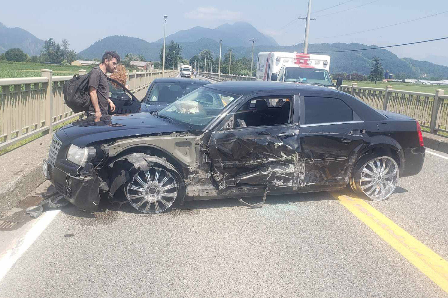 The scene of a four-vehicle crash on the Agassiz-Rosedale Bridge where this Chrysler 300 collided with three vehicles on July 8, 2023. (Sukh Mattu)