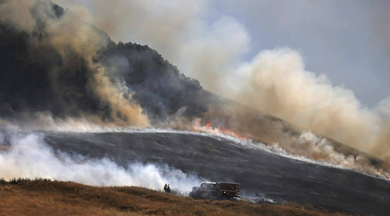 The San Antonio Fire spreads uphill west of Petaluma, Ca., Friday, June 30, 2023. The entire planet sweltered for the two unofficial hottest days in human recordkeeping Monday and Tuesday, according to University of Maine scientists at the Climate Reanalyzer project. The unofficial heat records come after months of unusually hot conditions due to climate change and a strong El Nino event. (Kent Porter/The Press Democrat via AP)