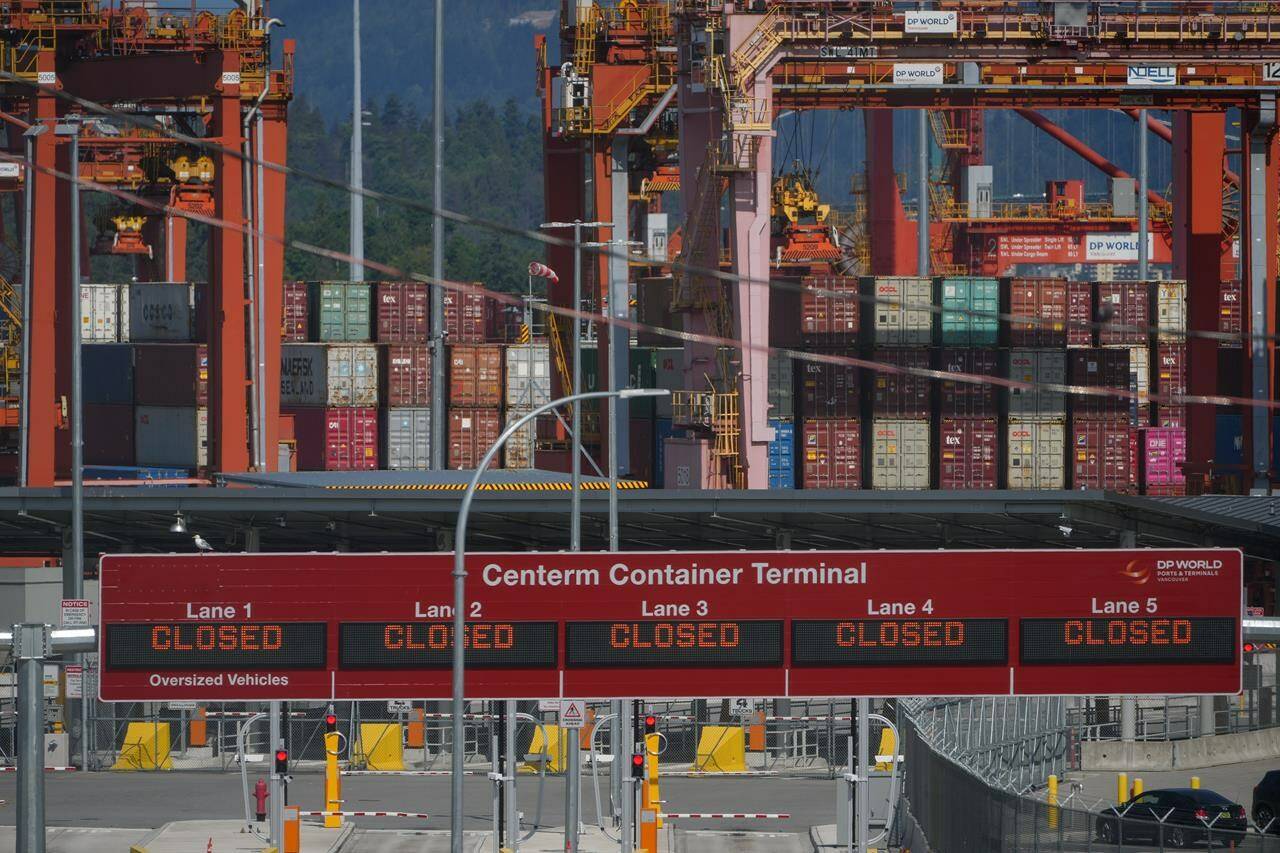 Signs displaying “closed” are seen at the Centerm Container Terminal during a strike by International Longshore and Warehouse Union Canada workers, at the port, in Vancouver, B.C., Tuesday, July 11, 2023. Railways are facing a sharp drop-off in container shipments as the strike by B.C. port workers halts more than half of steel-box cargo. THE CANADIAN PRESS/Darryl Dyck