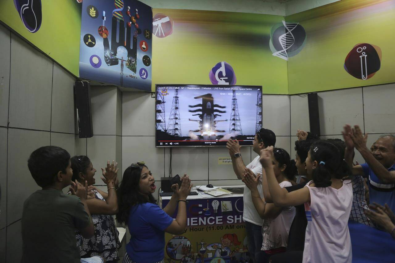 FILE- Indians cheer as they watch the on screen the lift off of Indian Space Research Organization (ISRO)'s Geosynchronous Satellite launch Vehicle (GSLV) MkIII carrying Chandrayaan-2 in Mumbai, India, Monday, July 22, 2019. Indian spacecraft Chandrayaan-3, the word for “moon craft” in Sanskrit, will blaze its way to the far side of the moon on Friday, July 14, 2023, a follow-up mission to its failed effort nearly four years ago to achieve a soft landing and roving on the lunar surface. (AP Photo/Rafiq Maqbool, File)
