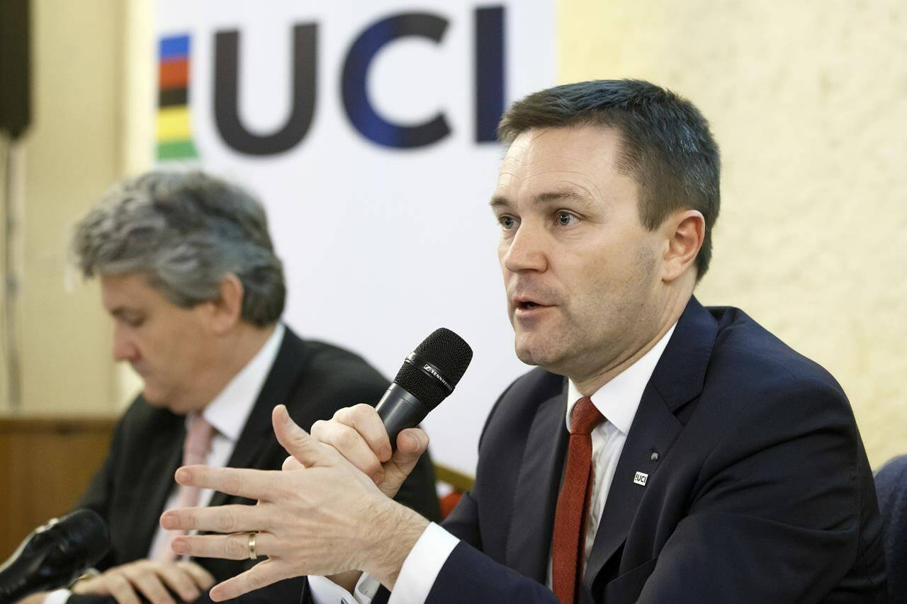 FILE - UCI President David Lappartient, right, speaks to the media about the fight against technological fraud during a press conference in Geneva, Switzerland, Wednesday, March 21, 2018. Female transgender athletes who transitioned after male puberty will no longer be able to compete in women’s races, world cycling governing body the UCI said Friday, July 14, 2023. Despite the ban, Lappartient said “the UCI would like to reaffirm that cycling — as a competitive sport, leisure activity or means of transport — is open to everyone, including transgender people, whom we encourage like everyone else to take part in our sport.”(Salvatore Di Nolfi/Keystone via AP, File)